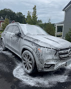 SUV covered in foam during a hand wash